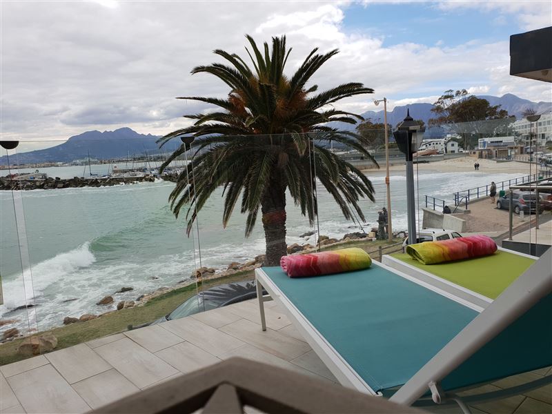 Fabulous private balcony with BBQ overlooking the beach and ocean one floor below