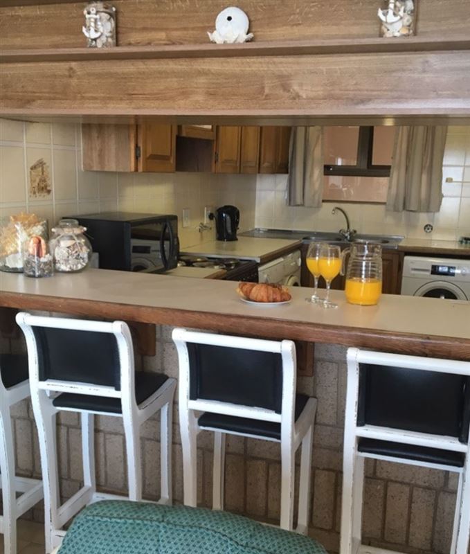 Breakfast bar - dining room table ( not shown) in same room - opens onto patio