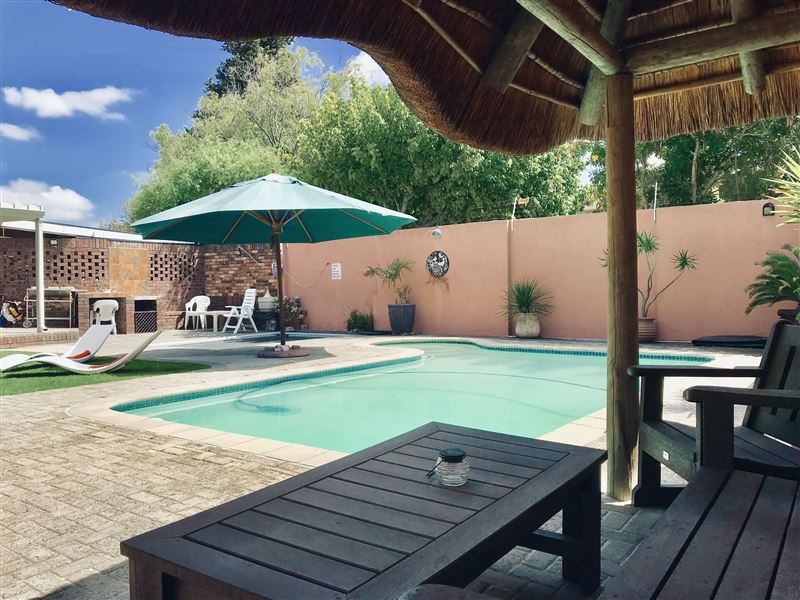 Thatched seating area at Pool Room entrance
