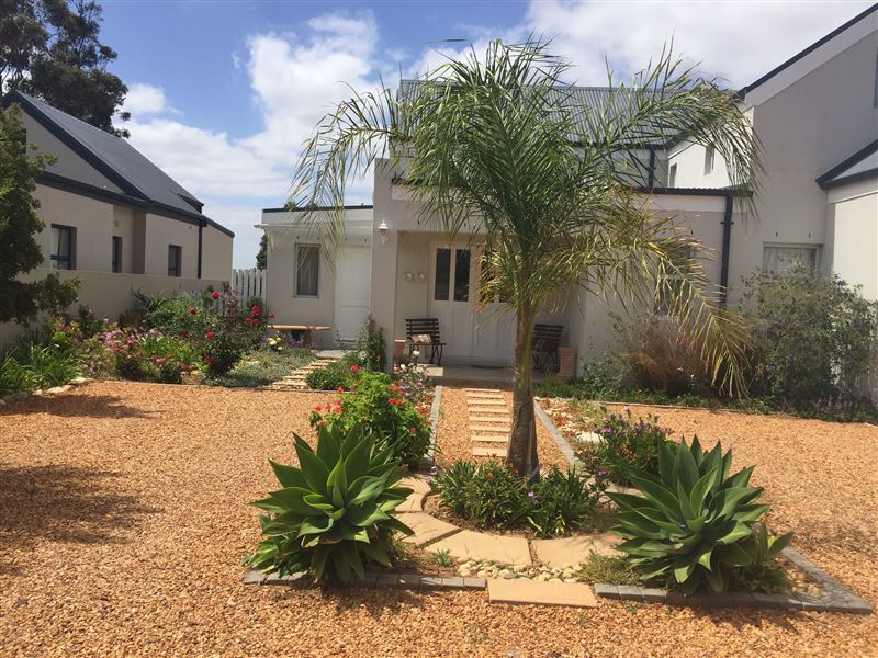 Entrance to FLAT and parking bay on pebbles on the left hand side of house