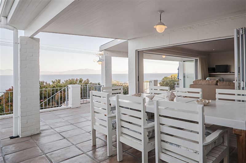 Sweeping sea views from the covered verandah, with outside eating area.