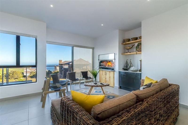 Enjoy beautiful ocean views while relaxing and having a braai. The sliding door opens up onto a patio area. © Vuuren Photography