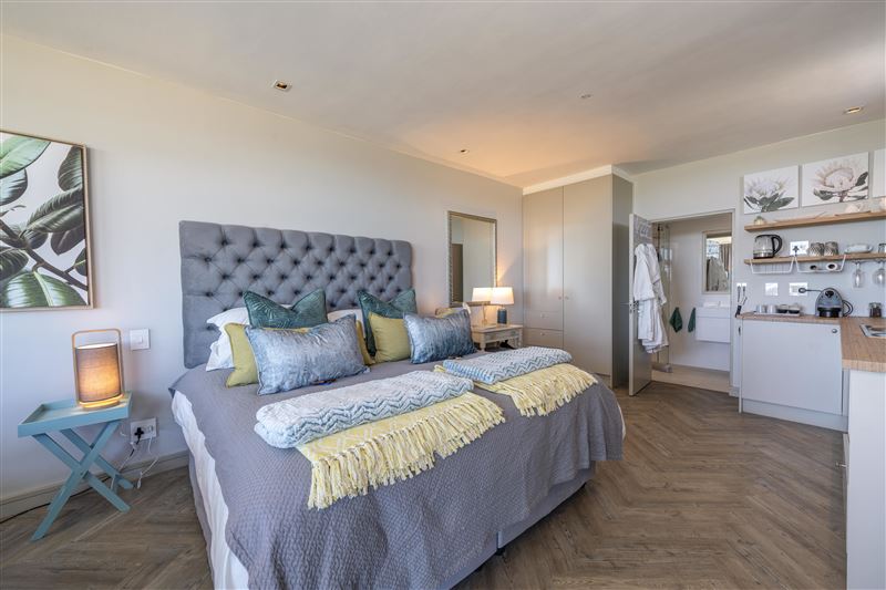 View of bed towards kitchenette and bathroom. You have a choice of extra length king size bed or 2 extra length singles