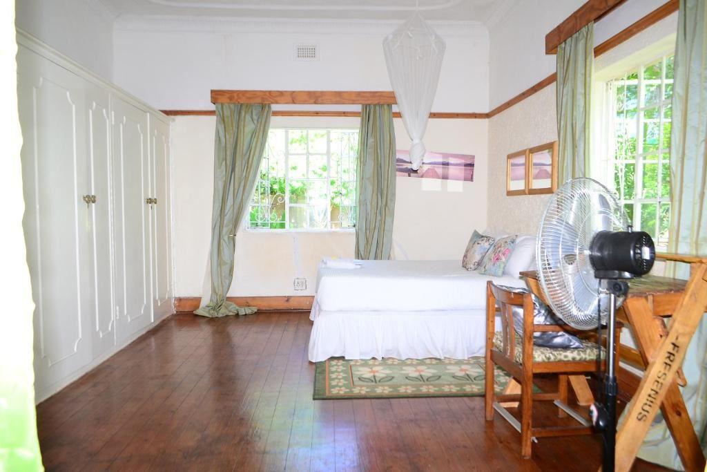 Step into this cozy Victorian-style guesthouse bedroom where you're greeted by charming wooden floors that add a touch of old-world elegance. The space is roomy, giving you plenty of breathing room to spread out and relax.

Draw back the curtains and treat yourself to a view of the sparkling pool outside, adding a dash of tranquility to your stay. The sunlight streaming in adds warmth to the atmosphere, making it the perfect spot to unwind after a long day of exploring.

Ready to kick back and relax? Slip into the sunken bathtub for a luxurious soak, surrounded by classic Victorian vibes. It's the ultimate way to pamper yourself and melt away any stress.

Stay connected with the included WiFi and catch up on your favorite shows on the TV, because a little downtime is always a good idea. And when it's time for a pick-me-up, brew yourself a cup of tea with the handy tea-making facilities.

This room is your cozy retreat, blending timeless charm with modern comforts for a truly memorable stay. So go ahead, sink into comfort and make yourself at home in this inviting Victorian haven.