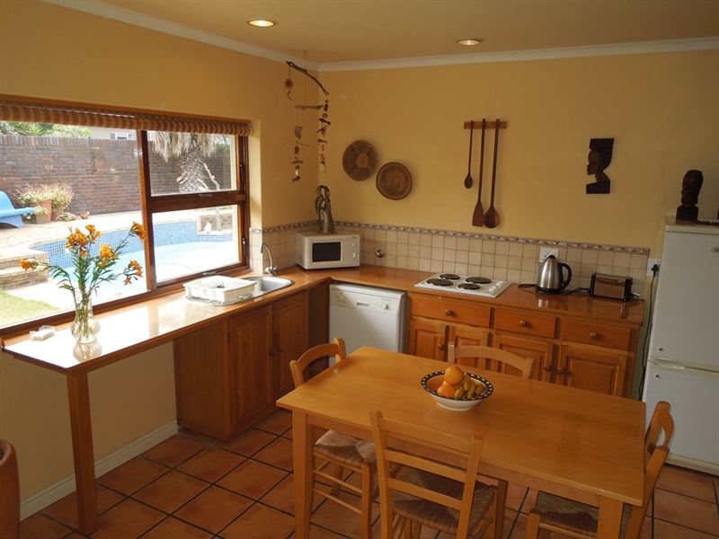 Kitchen area opens onto garden and pool.